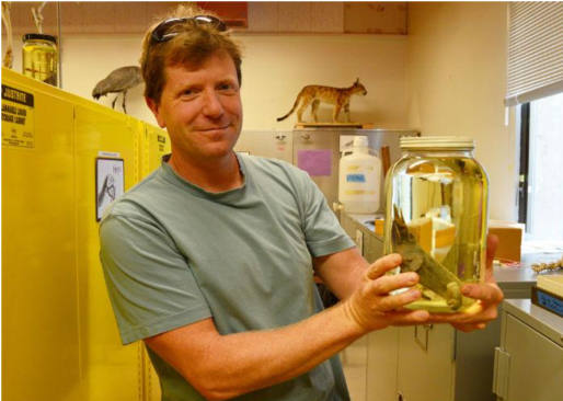chris lay with a jar of specimens