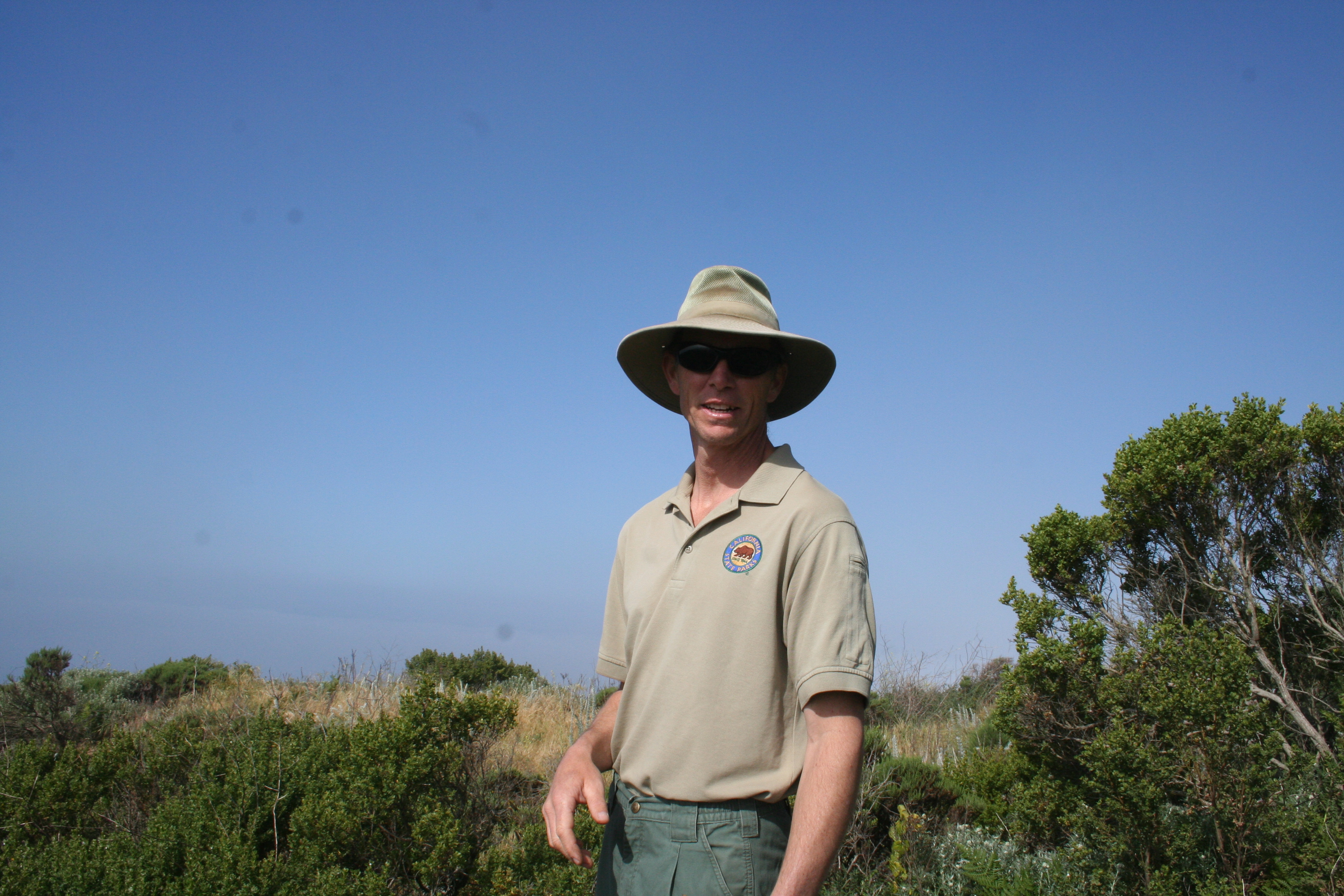 tim hyland in the sun with a wide-brimmed hat