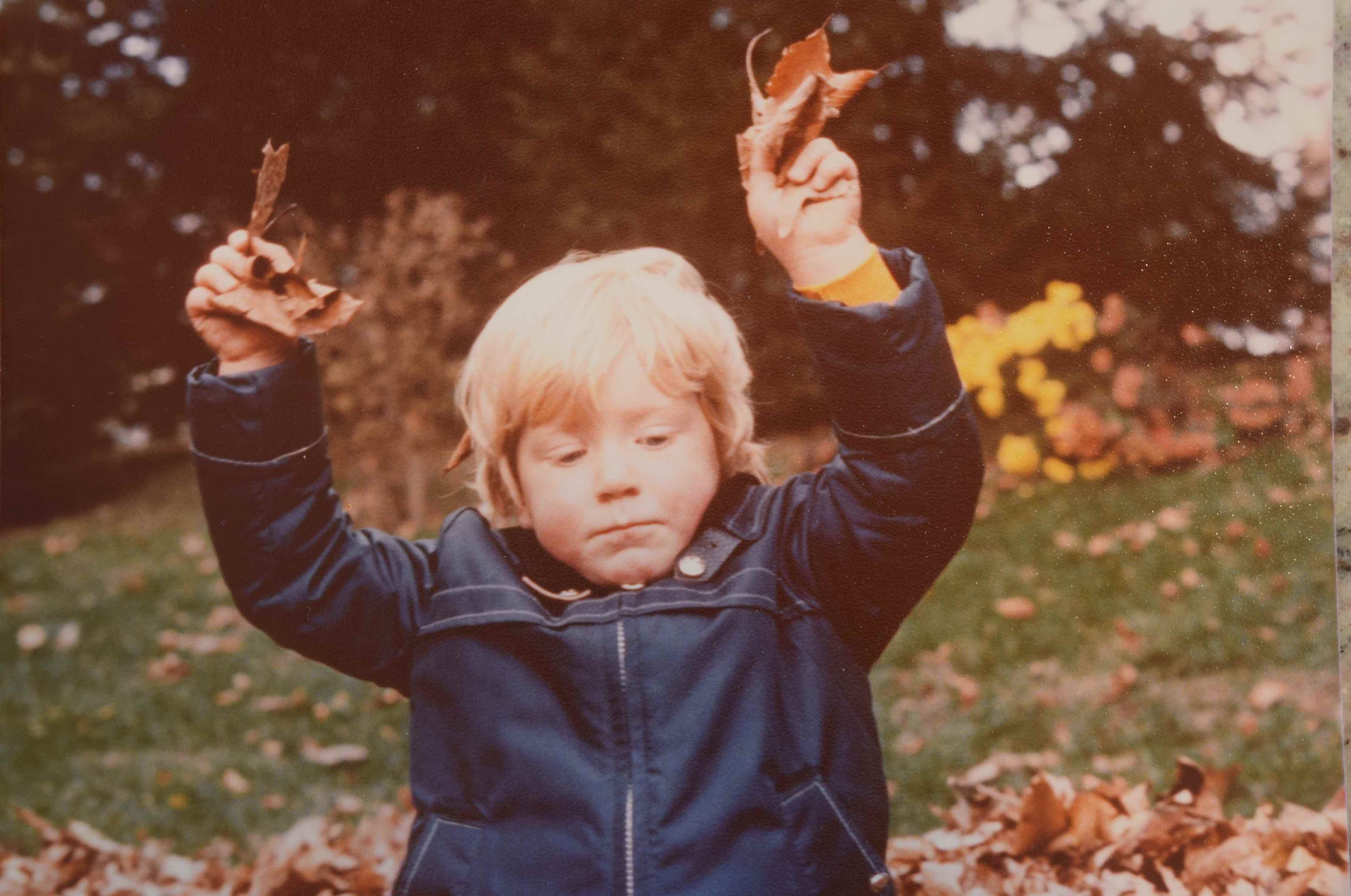 chris lay as a kid holding leaves